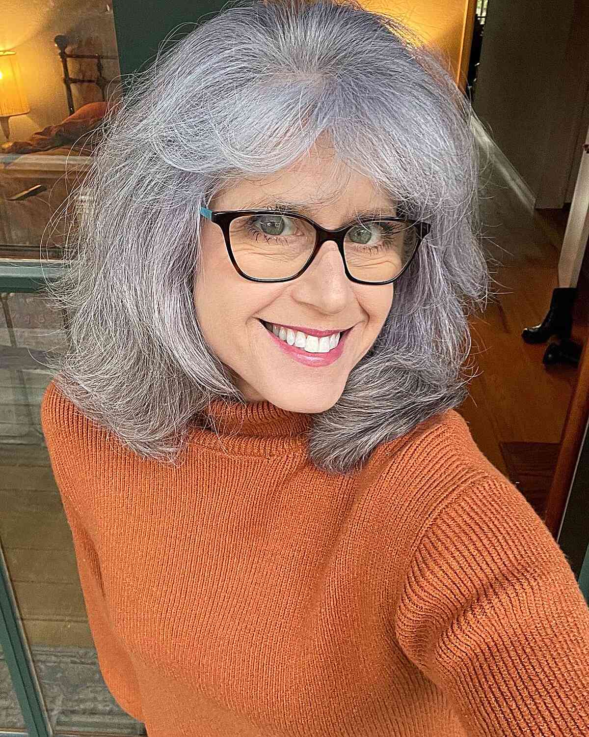Shoulder-Length Cut with Feathered Layers and Bangs on 50-Year-Old Women with Glasses