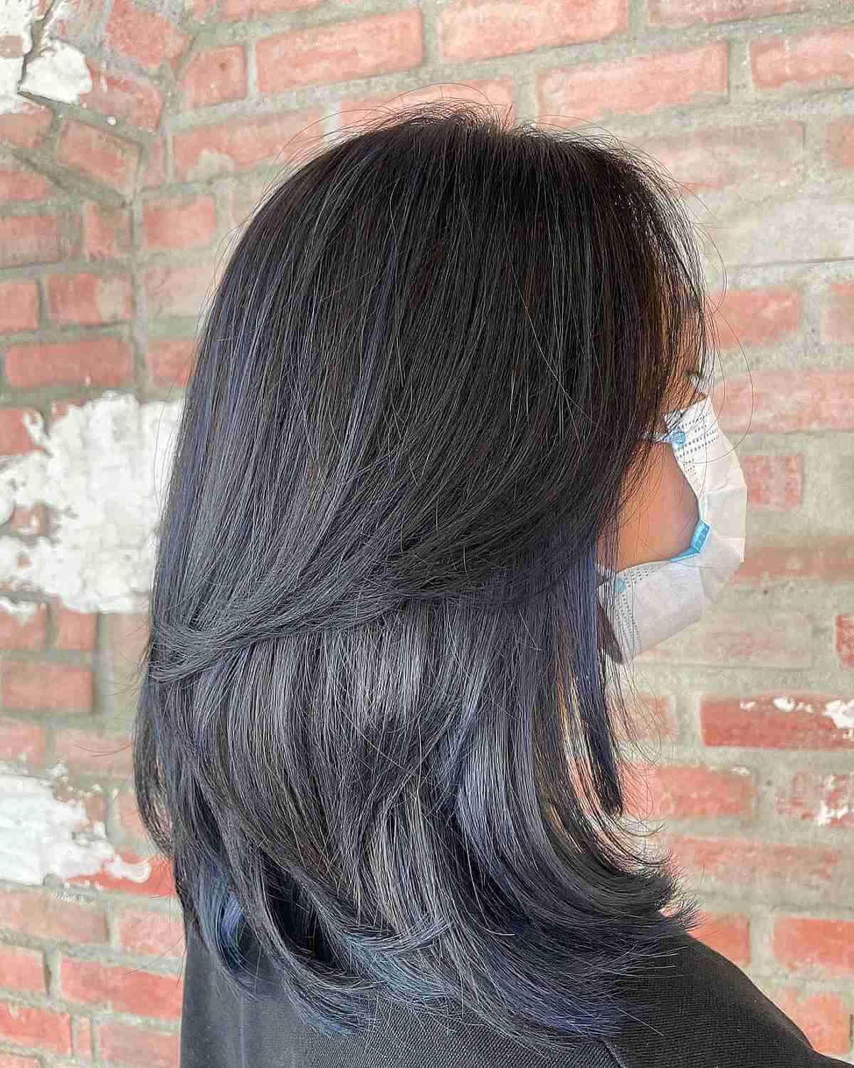 Shoulder-Length Layered Hair with Deep Blue Streaks