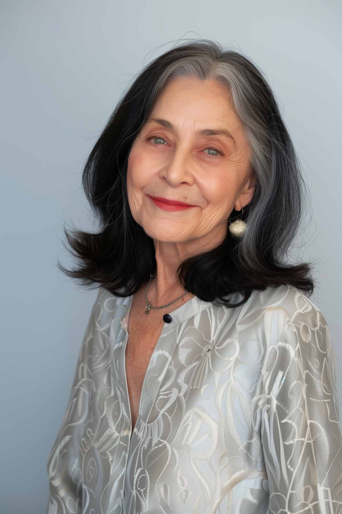 Shoulder-length grey hair with layers and a middle part on an older woman