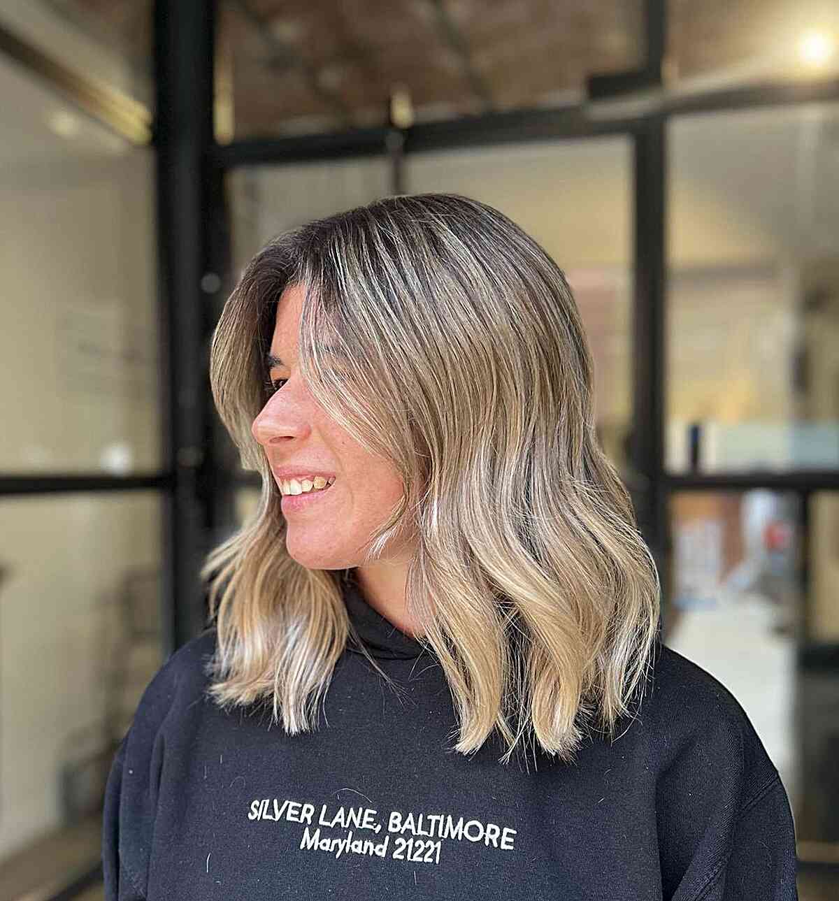 Shoulder-Length Light Blonde Balayage Hair with Black Roots and Subtle Layers