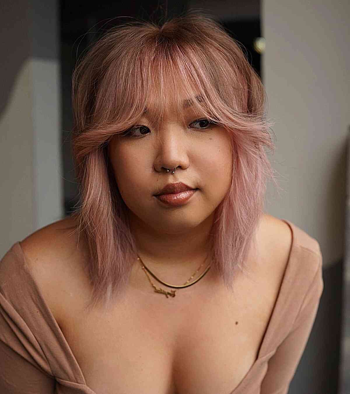 Shoulder-Length Pink Balayage Bob with Feathered Bangs on Ladies with a round jawline