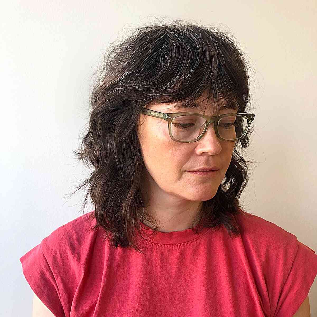 Shoulder-Length Shag with Heavy Bangs on Ladies Aged 50 and Up