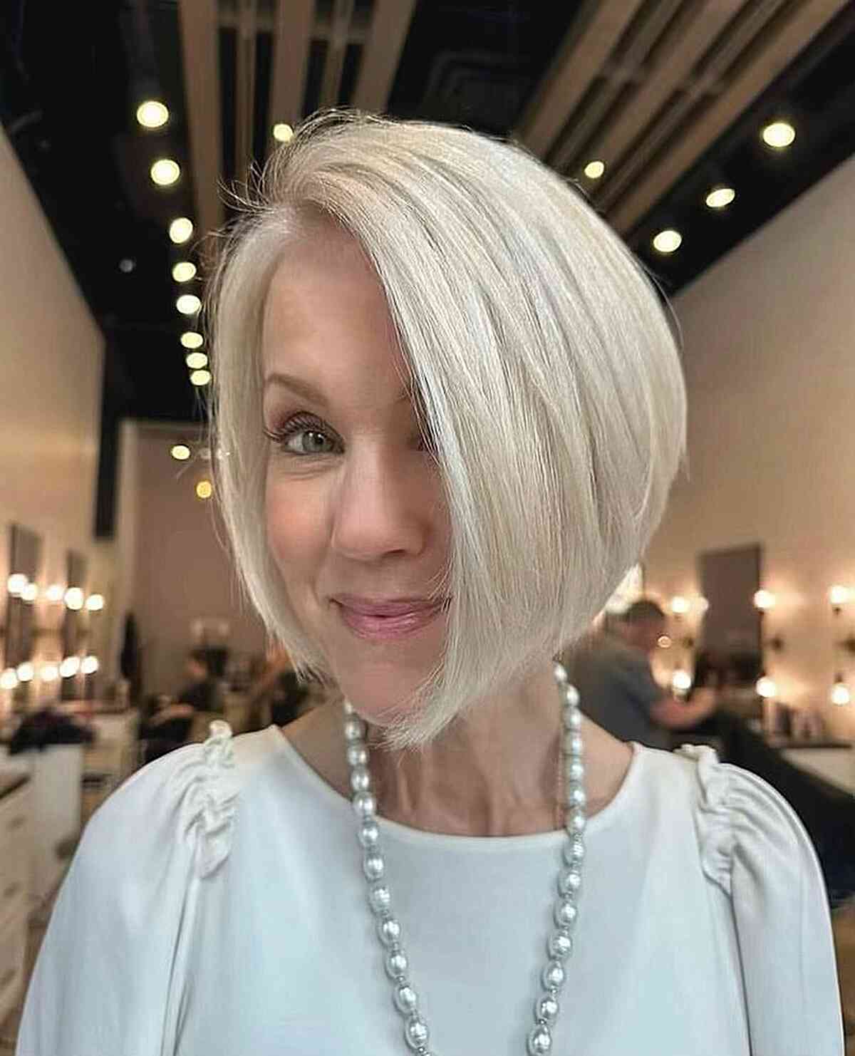 side parted angled bob for woman aged 50 with round face