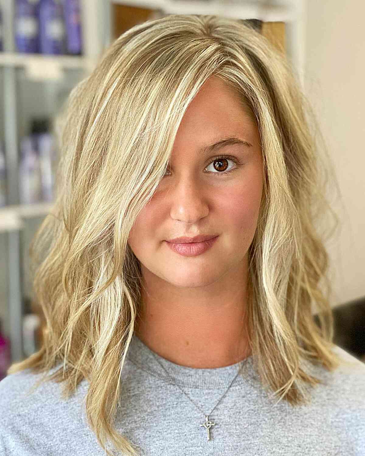 Side-Parted Medium-Length Waves on a Blonde Lob for Round Faces