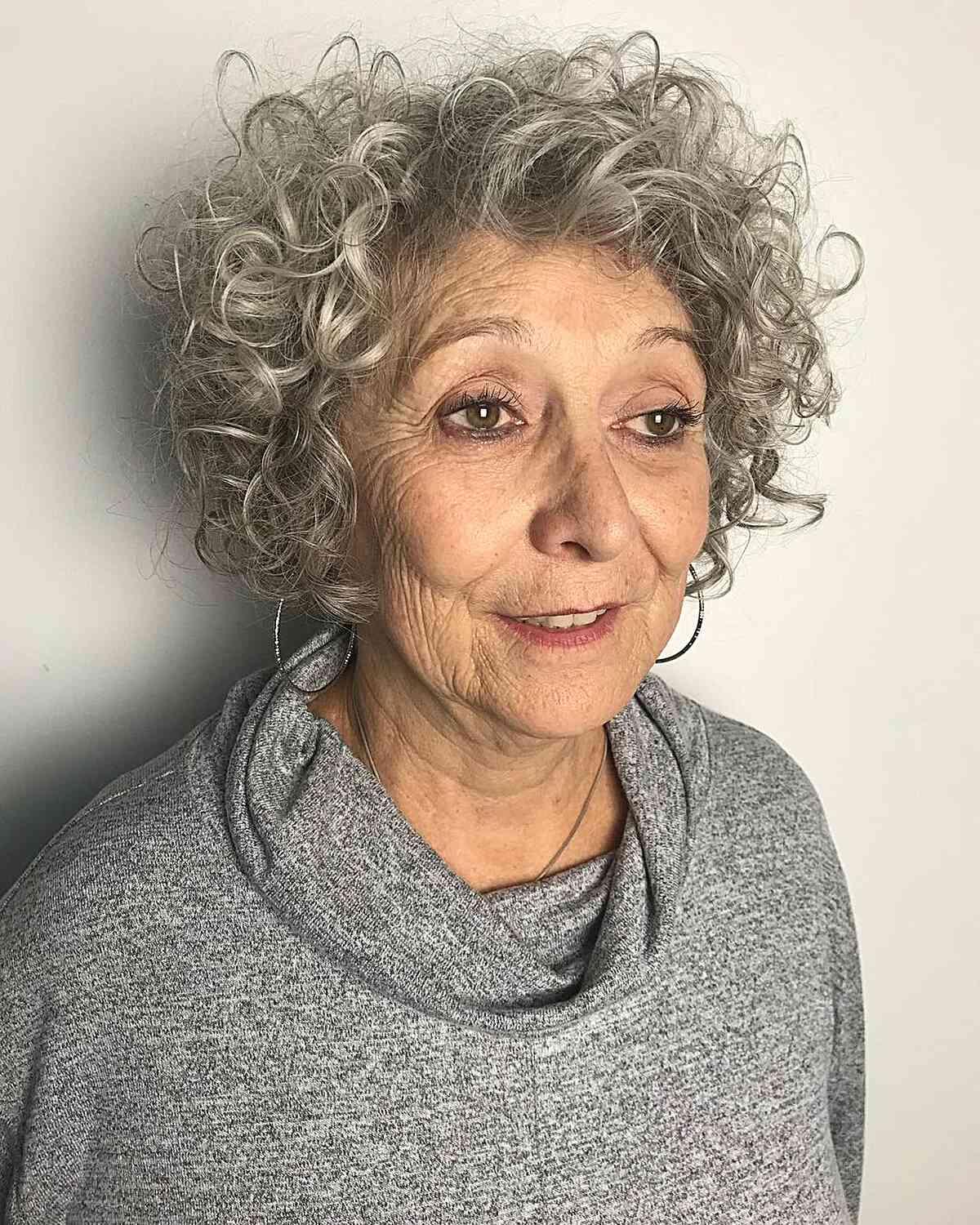 Jaw-Grazing Silver Grey Hair with Bouncy Curls for seniors aged sixty
