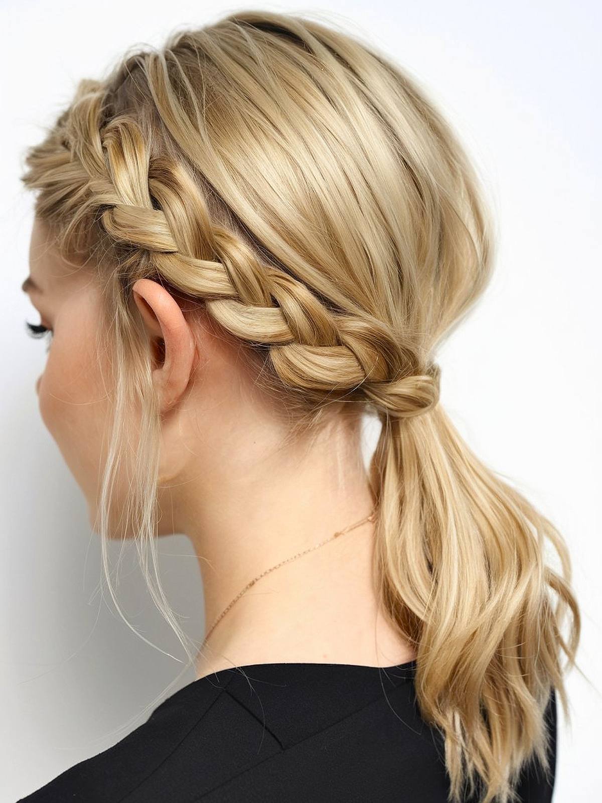 Medium-length hair in a side braid leading into a low ponytail, creating a stylish and practical look