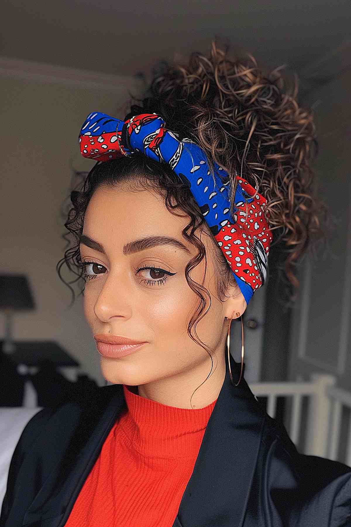 Curly hair in a high ponytail with a red and blue headband for Independence Day