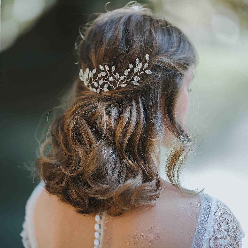 Romantic half-up half-down wedding hairstyle with soft curls and hair vine