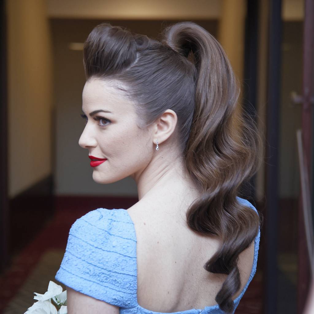 Retro homecoming long hairstyle with voluminous curls and high ponytail