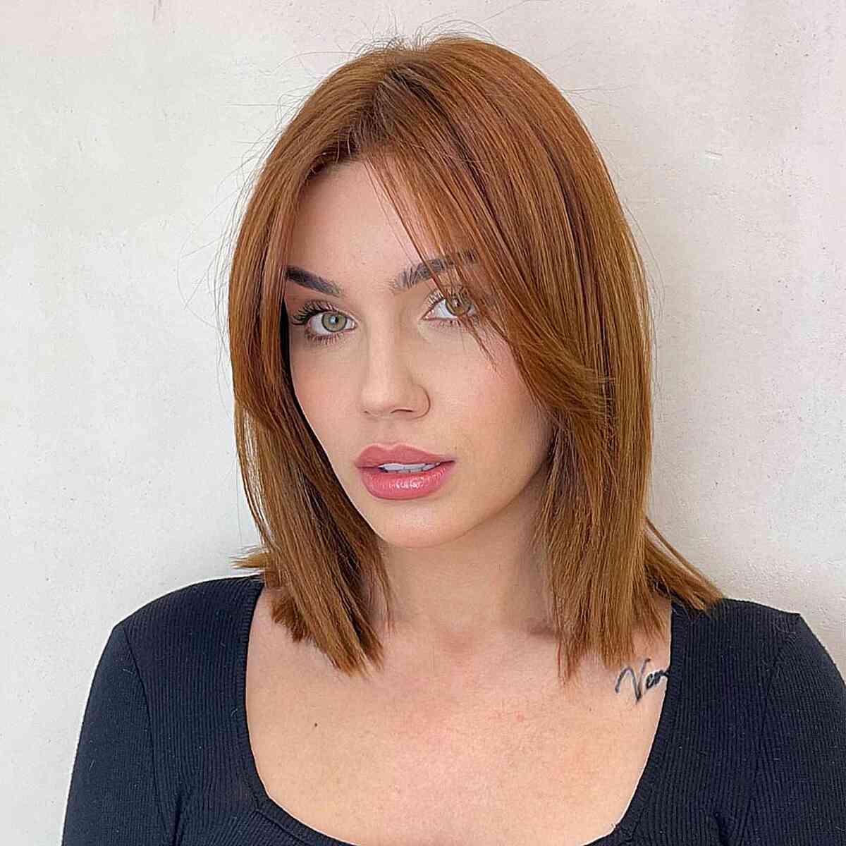 Simple Lob with Wispy Long Bangs Hairstyle for women with heart faces and copper hair