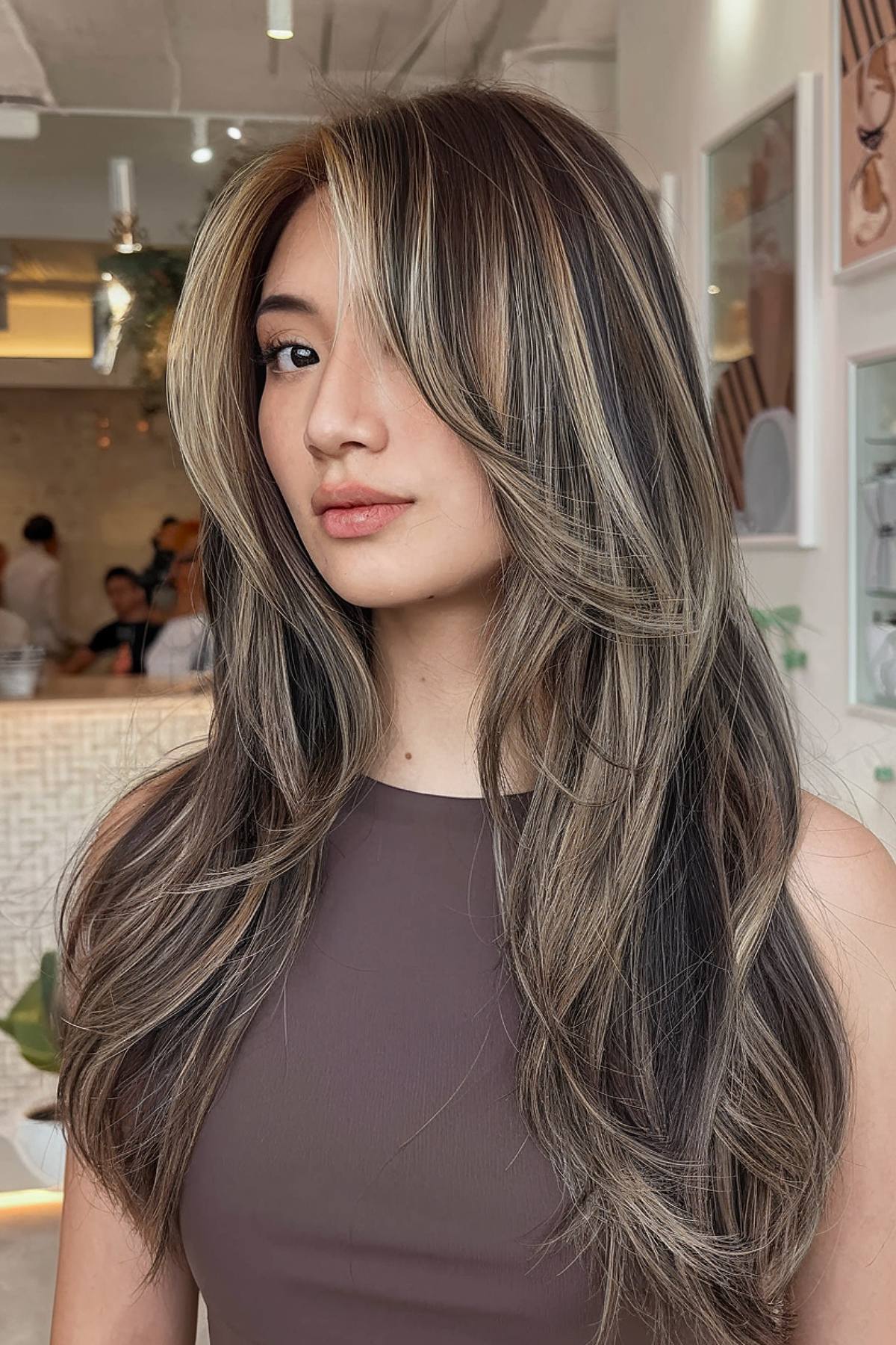 Asian layered haircut with dimensional highlights and face-framing layers