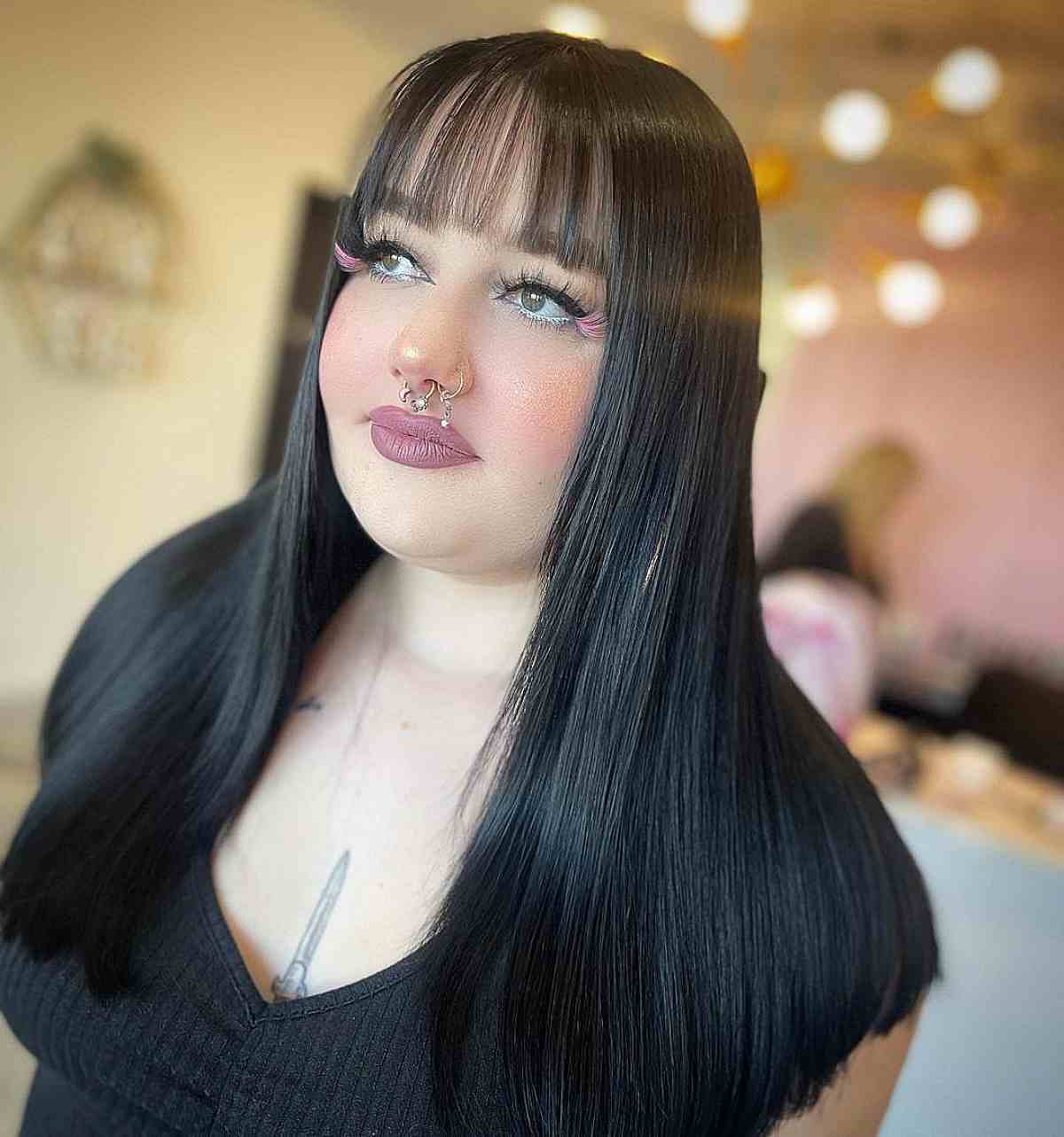 Sleek Black Hair with See-Through Wispy Bangs for Round Face Shapes