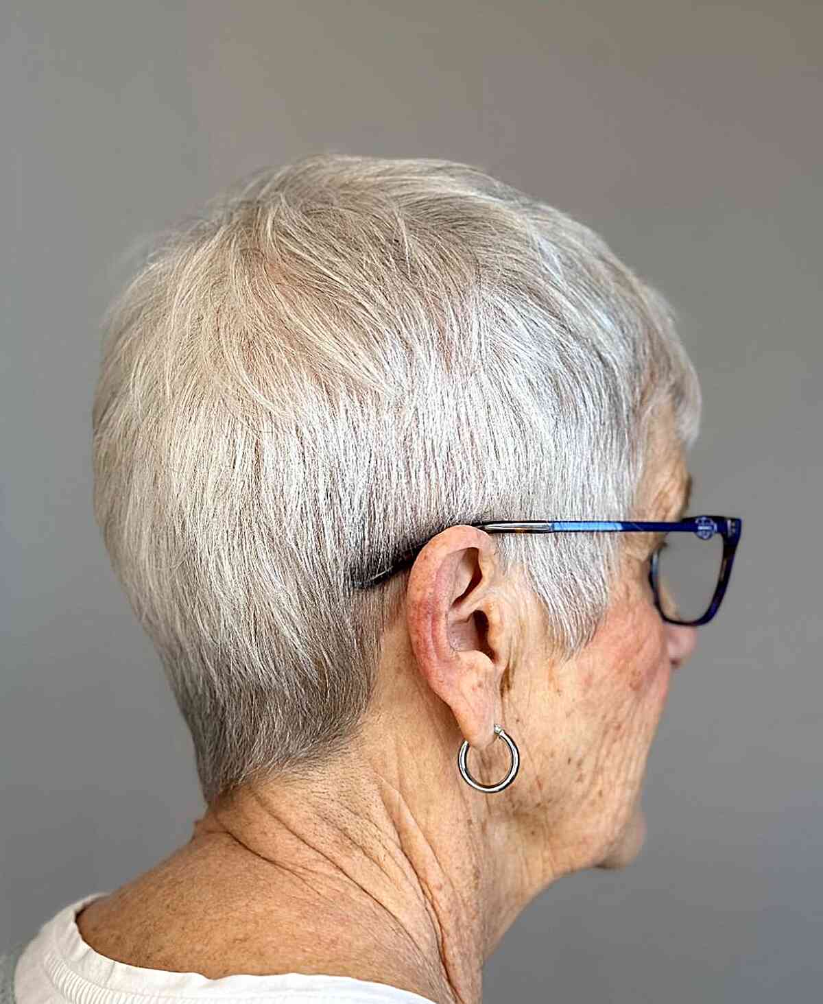 Sleek Cropped Pixie Cut for 60-year-old Ladies with Specs