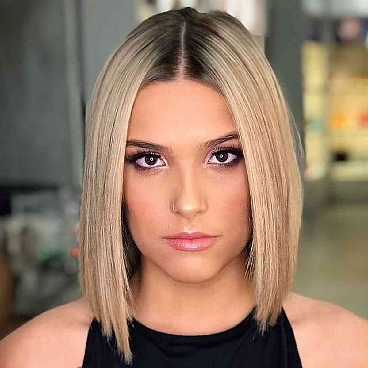 Rooted Blonde Sleek Long Bob Slob Hairstyle with Sharp Edges