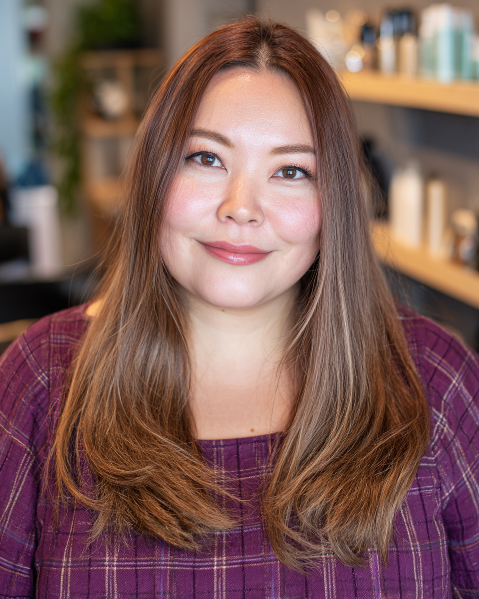 Sleek long layered haircut with subtle volume, perfect for enhancing movement in straight, thick hair