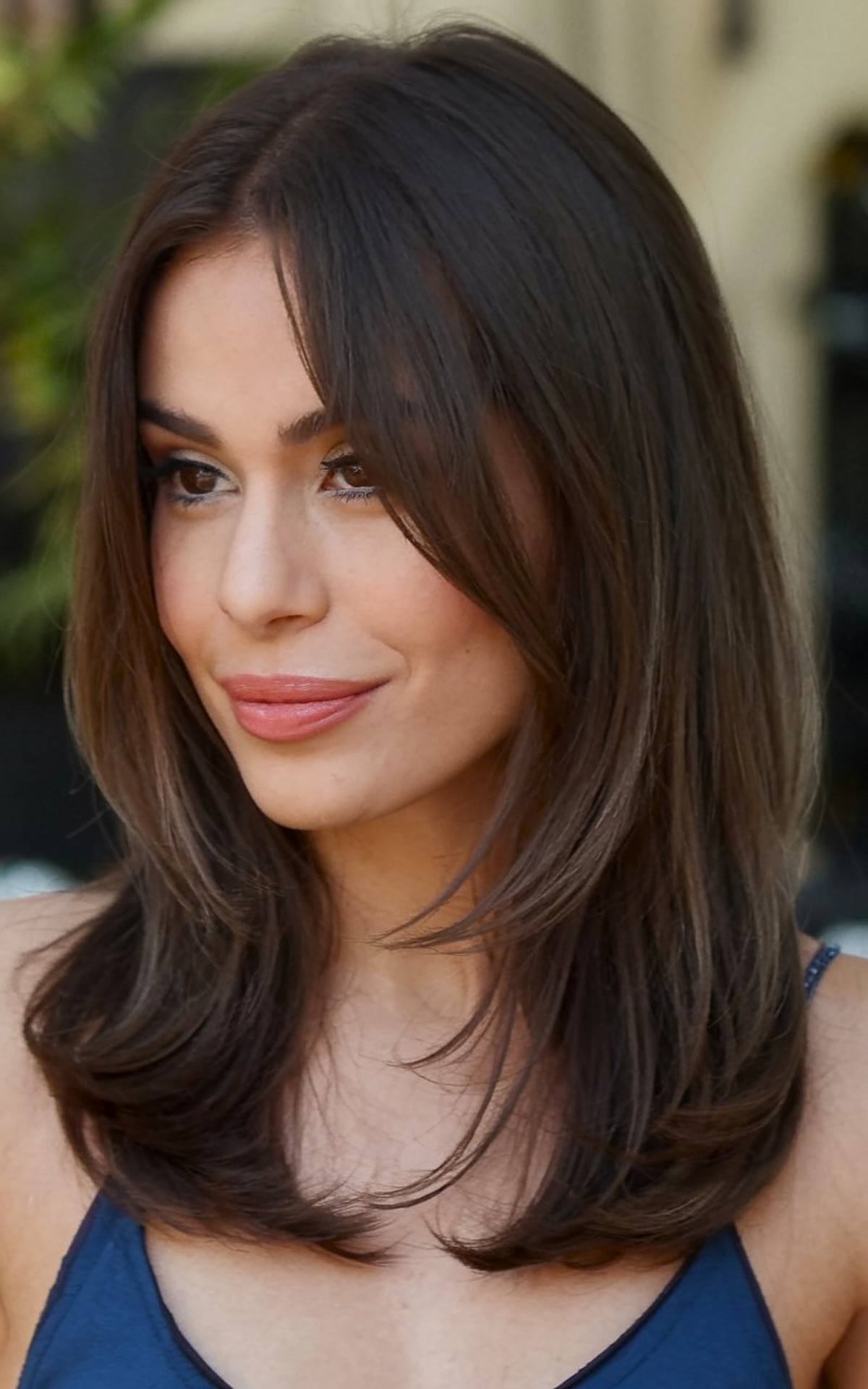 Medium-length straight hairstyle with soft layers for a sleek and polished look