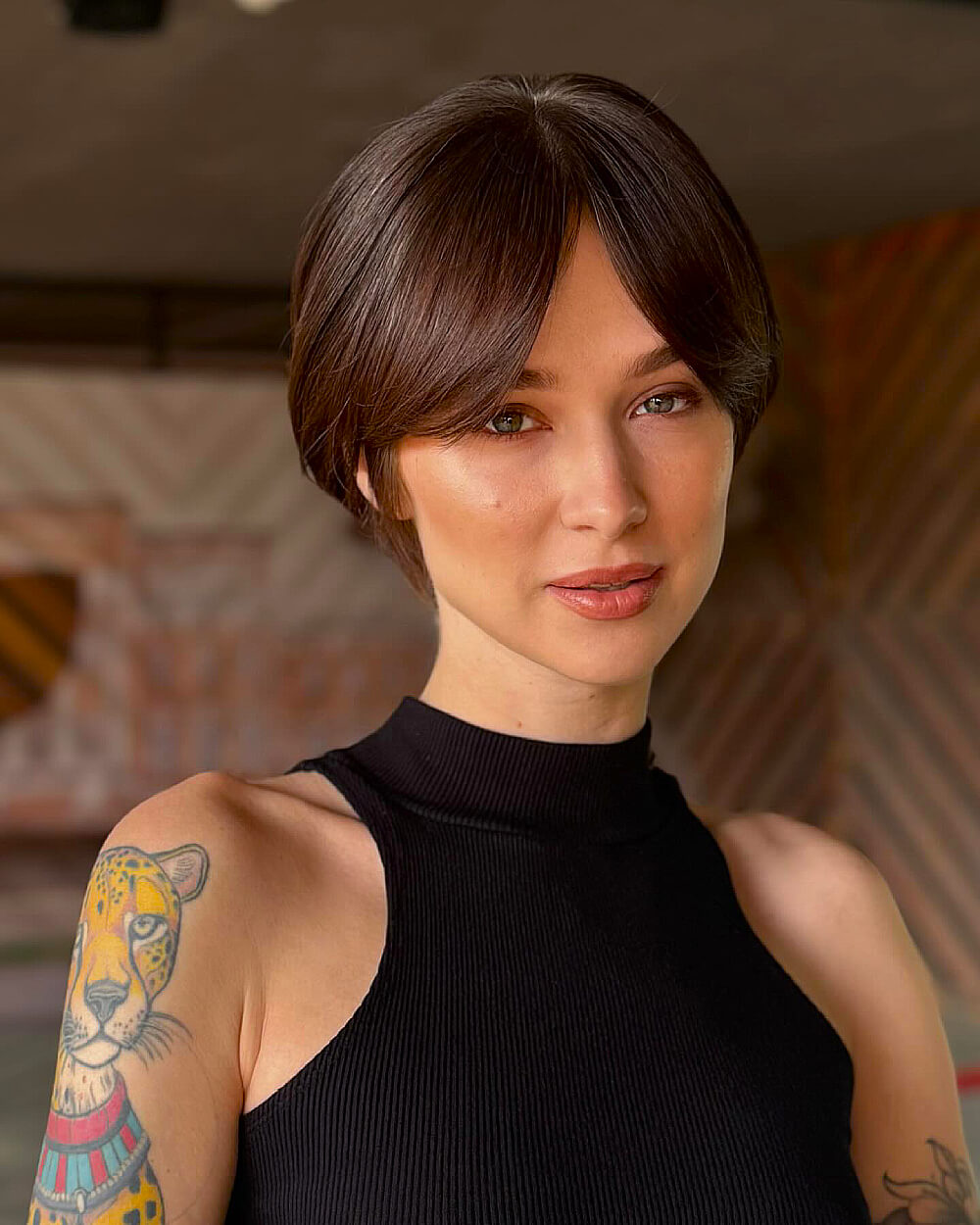 Sleek short brunette tapered bob with curtain bangs for straight medium-density hair