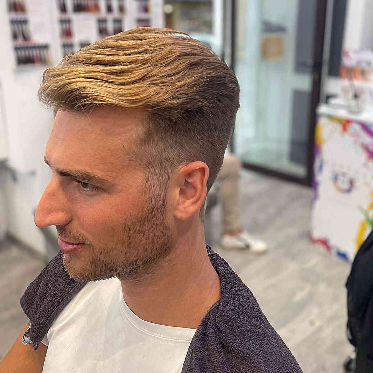 Slicked Back Faux Hawk Style with Blonde Highlights on Young Men