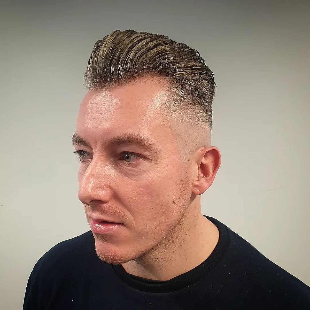 Slicked Back Short Hair with a Bald Fade for Men with Thin Hair
