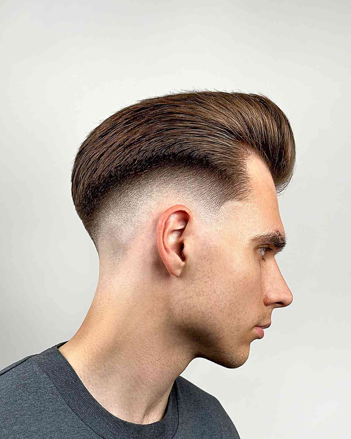 Slicked Up Pomp with a Mid Fade for Guys with thick hair