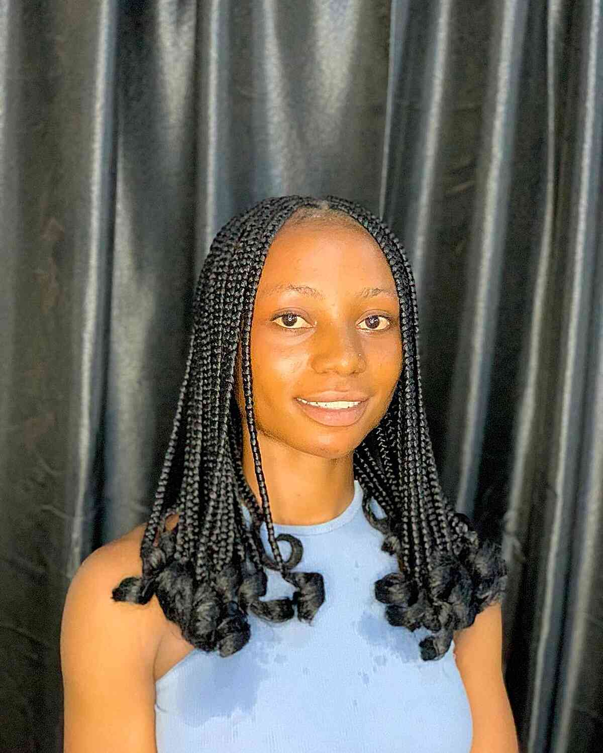Small Knotless Braids with Curled Ends for Women's Mid-Length Hair