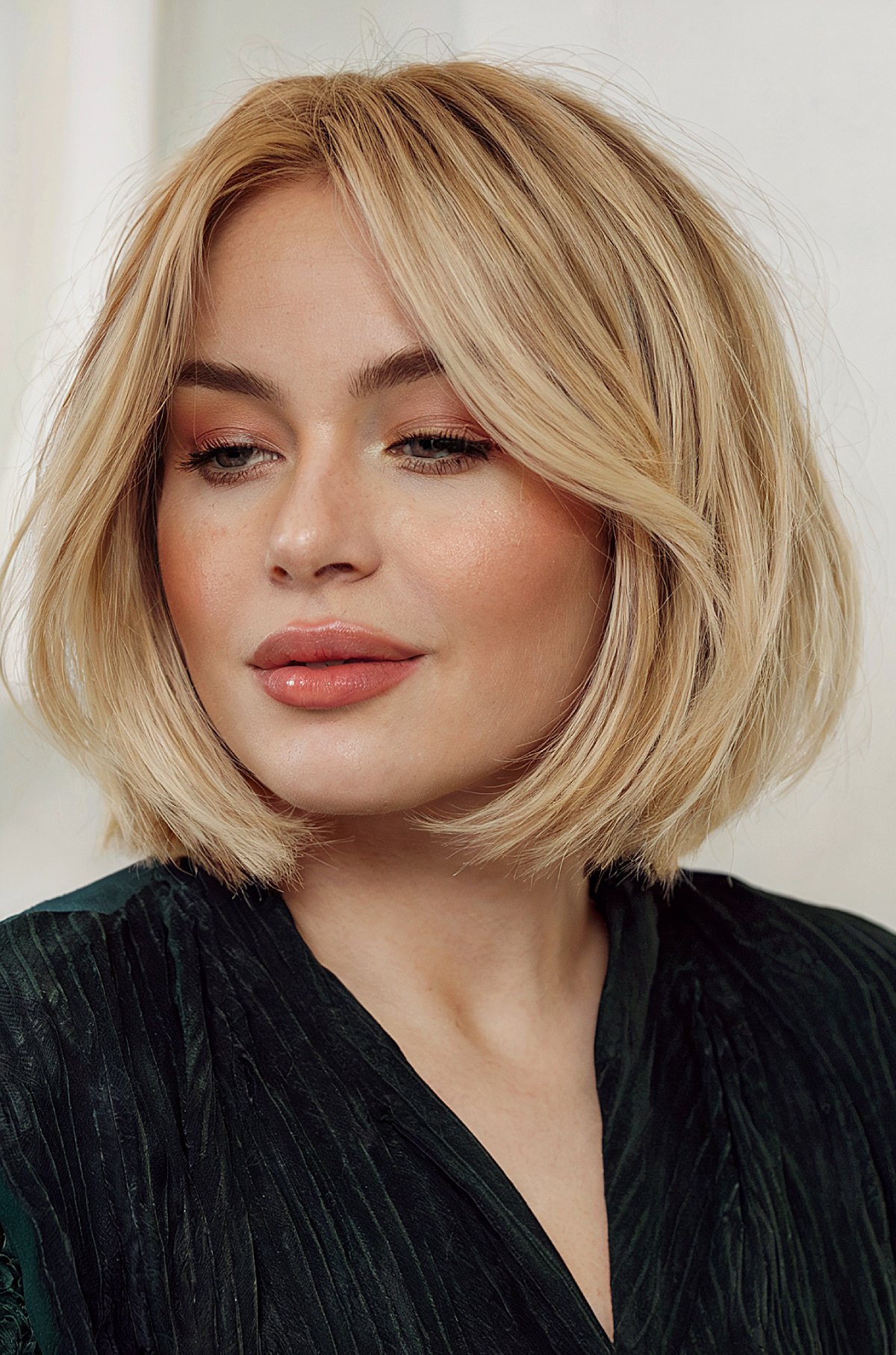 Soft blonde bob with curtain bangs hairstyle