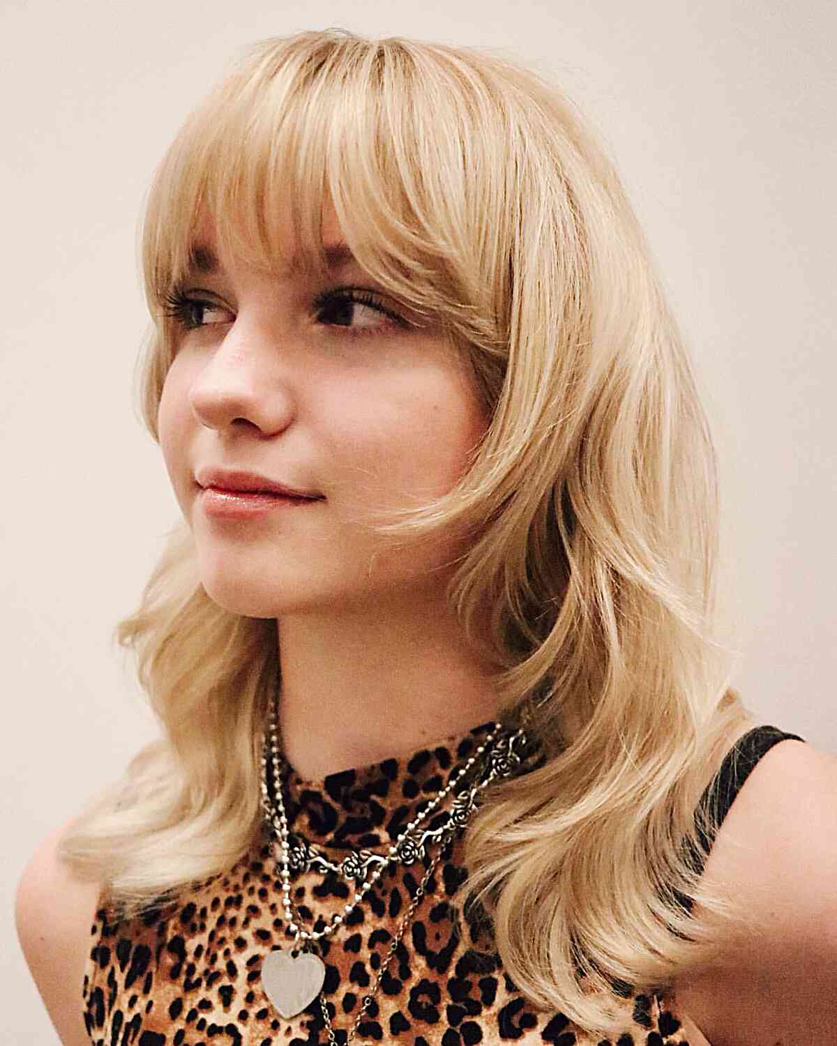 Soft Blonde Wolf Cut with Bangs for women with mid-length hair