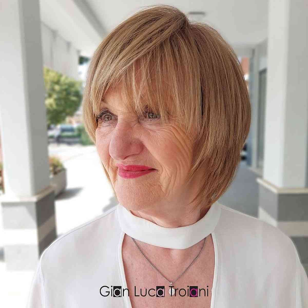 Soft Copper Bob with Side-Swept Wispy Bangs for 70-Year-Old Ladies