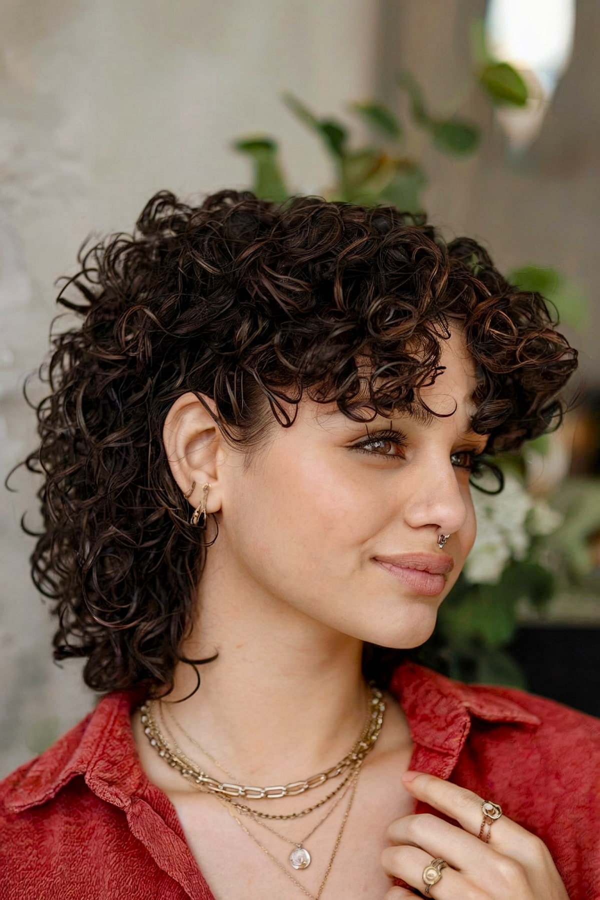 Feminine curly mullet haircut with rounded layers