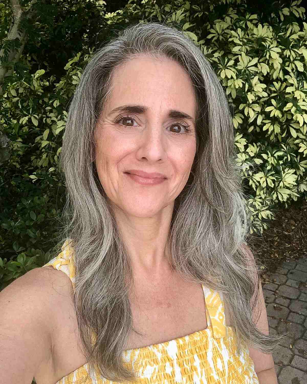 Soft Layers on Longer Hair for a 50-Year-Old Woman