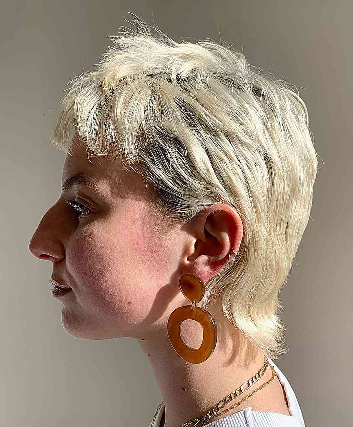 Soft Pixie Mullet with Jagged Layers on Bleach Blonde with Dark Roots
