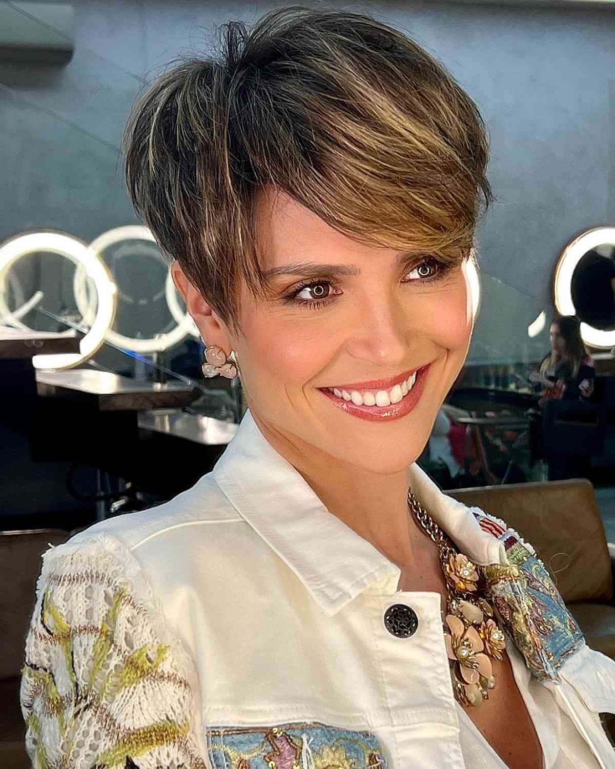 Soft Pixie with Side-Swept Bangs and Blonde Highlights 