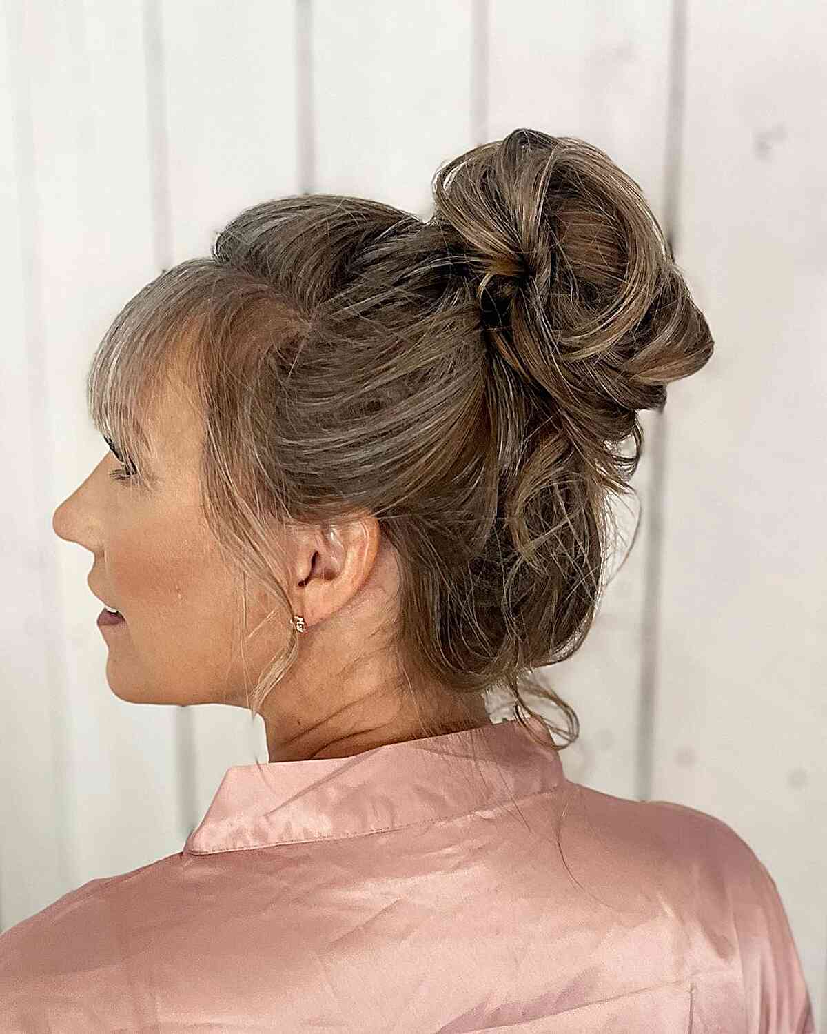 Soft Textured High Bun Updo with Straight Bangs