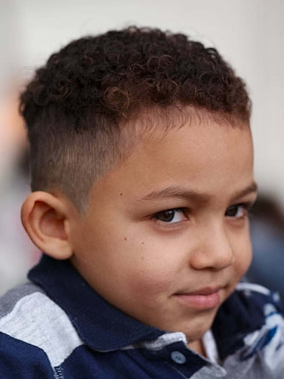 Toddler boy haircut for 4C hair with close-cropped curls and fade