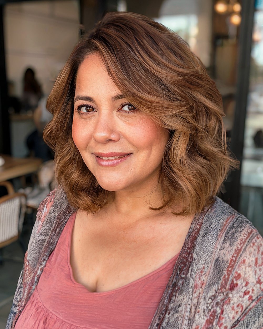 Collarbone-length cut with soft waves and side-swept volume for round-faced women over 40