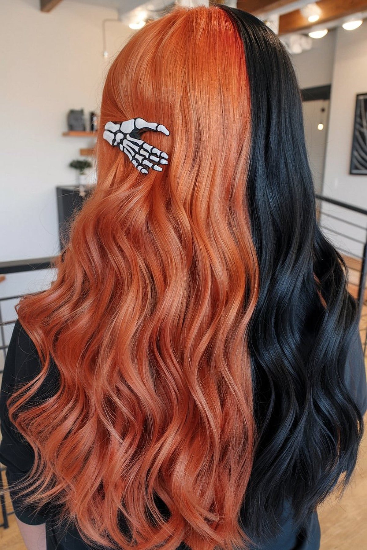 Long wavy split-dyed hair in orange and black with skeleton hair clip