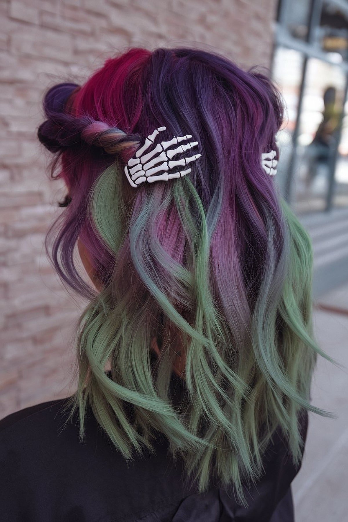 Half-up hairstyle with purple and green hair and skeleton clips