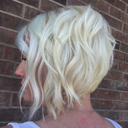 A white blonde stacked short swing bob haircut