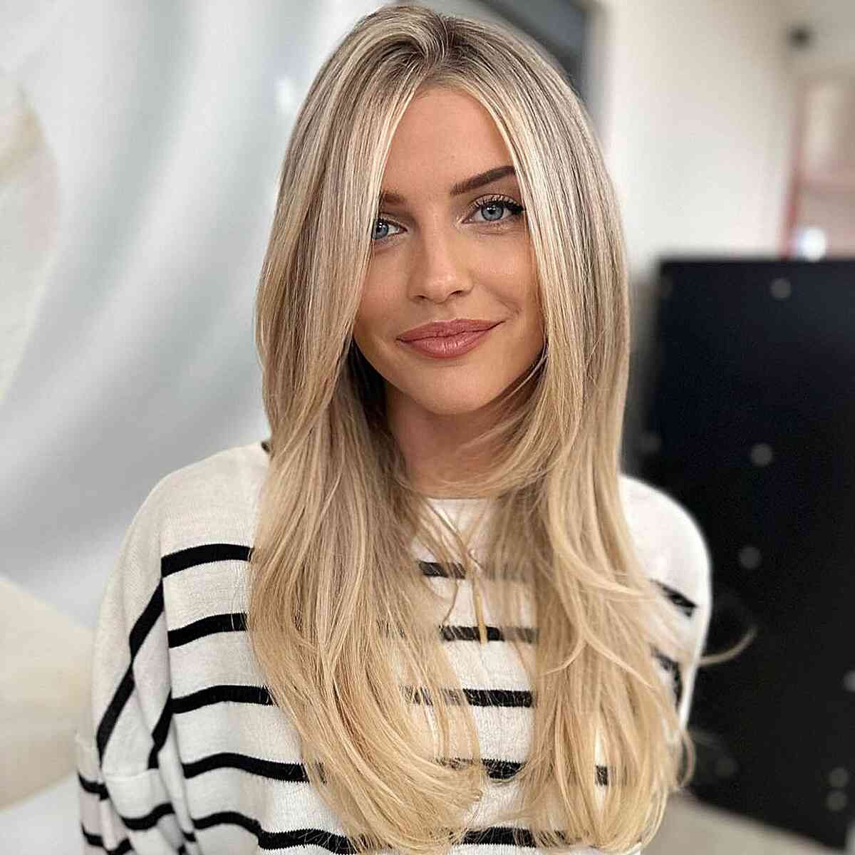 Straight Blonde Balayage with a Subtle Side Part
