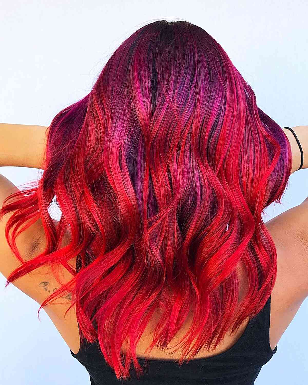 Stunning Bright and Vivid Red Balayage Hair Color on medium-length wavy hair