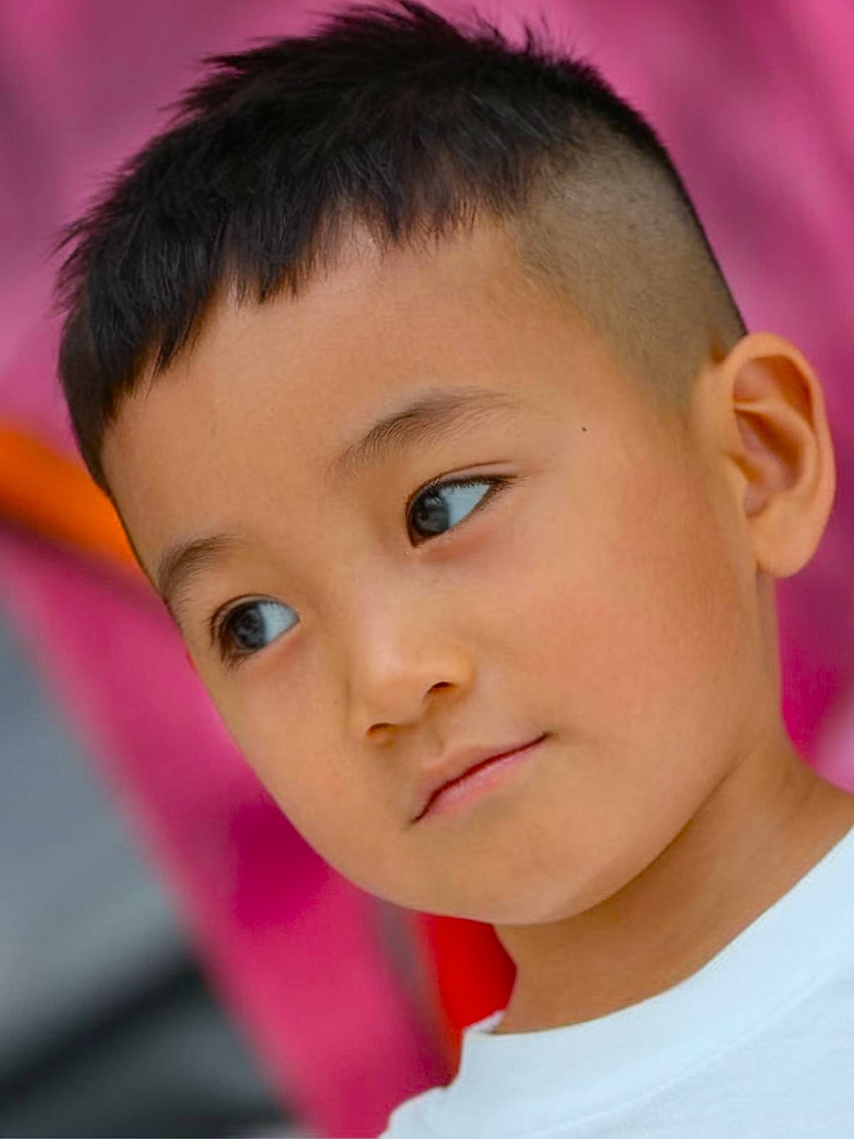 Asian toddler boy haircut with textured top and shaved sides