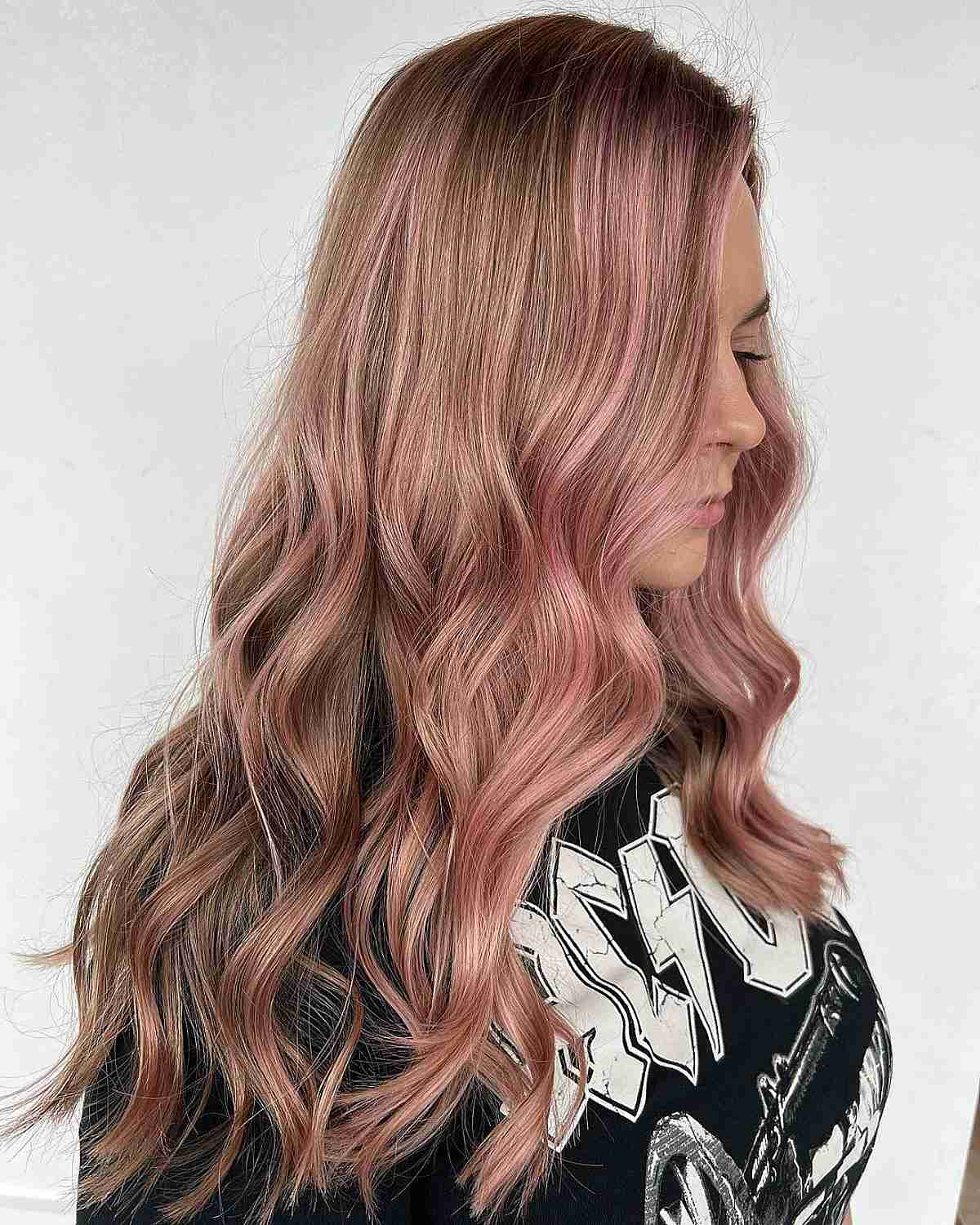 Subtle Rose Gold highlights on long light brown hair with added waves