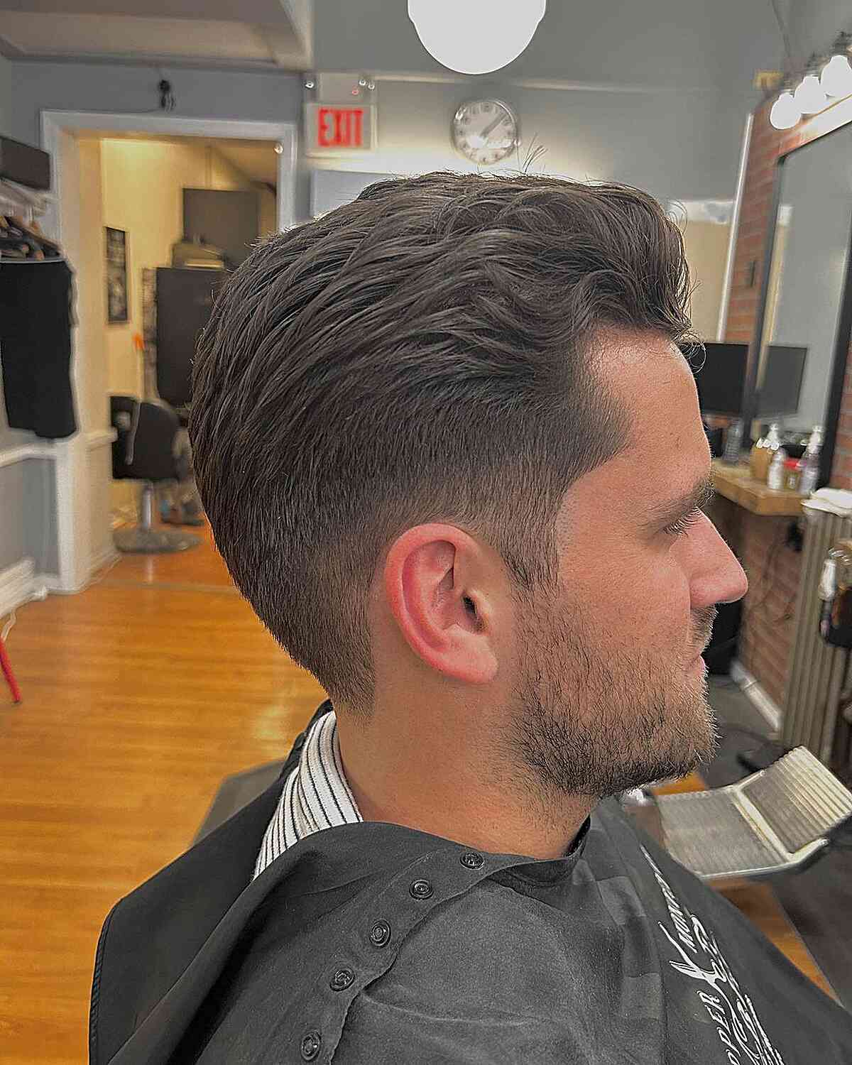 Subtle Wavy Slick Back with Low Taper Fade on Guys with Straight Hair