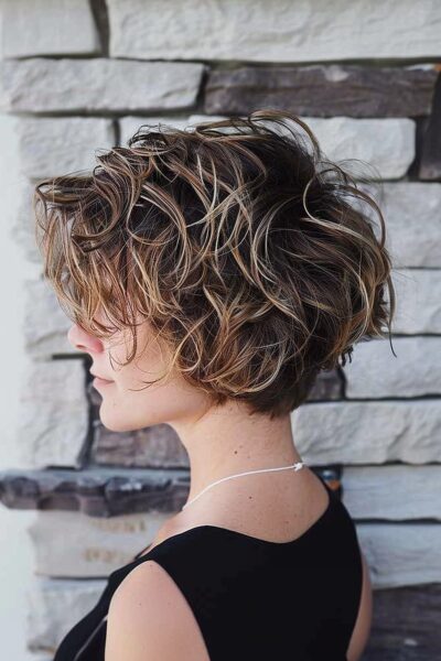 A Short Wavy Layered Bob with Sun-Kissed Highlights