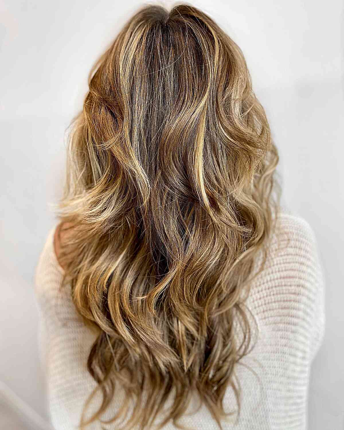 Long Dimensional Sun-Kissed Warm Blonde Balayage Hair with Messy Waves