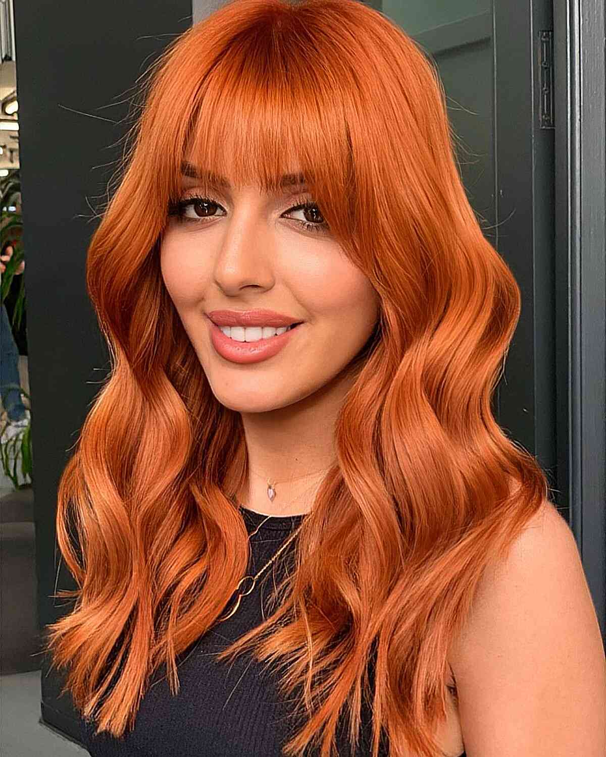 Sunset-Inspired Red Hair with Wispy Bangs