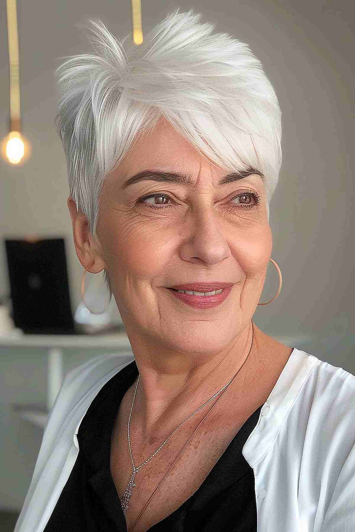 Super short crop pixie hairstyle for older women with white hair