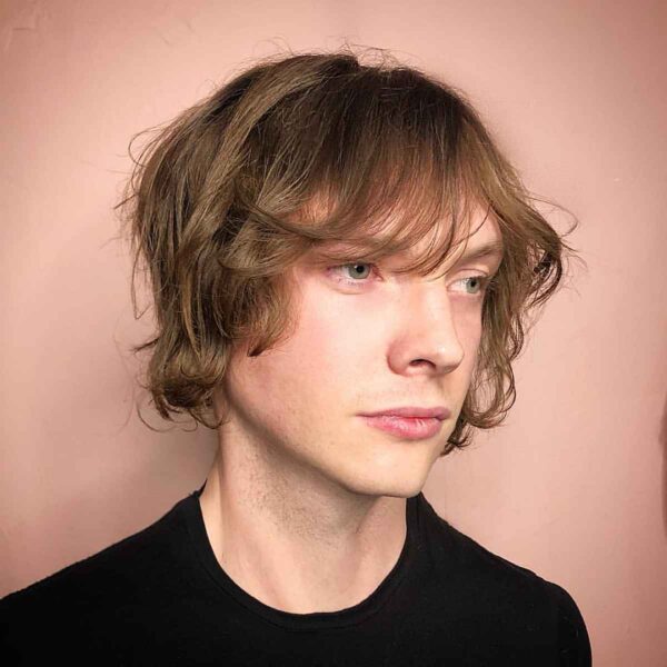 A Surfer Shag haircut on a teen boy