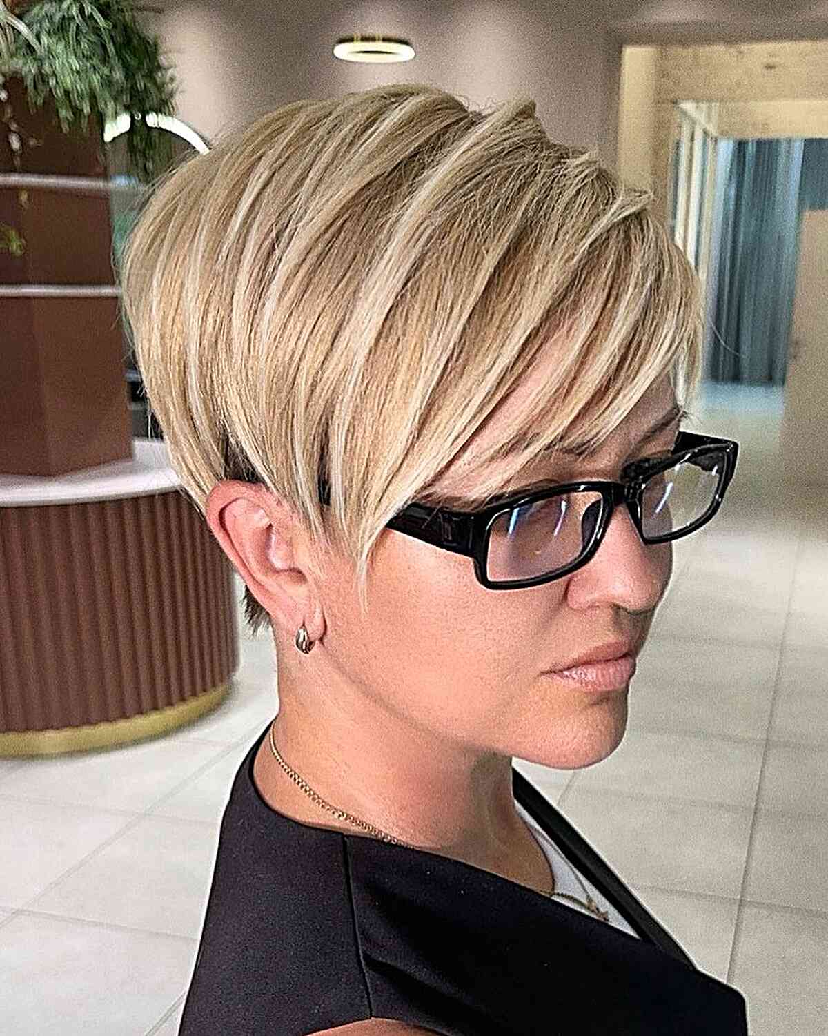Sweeping Bangs on a Long Blonde Straight Pixie Cut for ladies with glasses