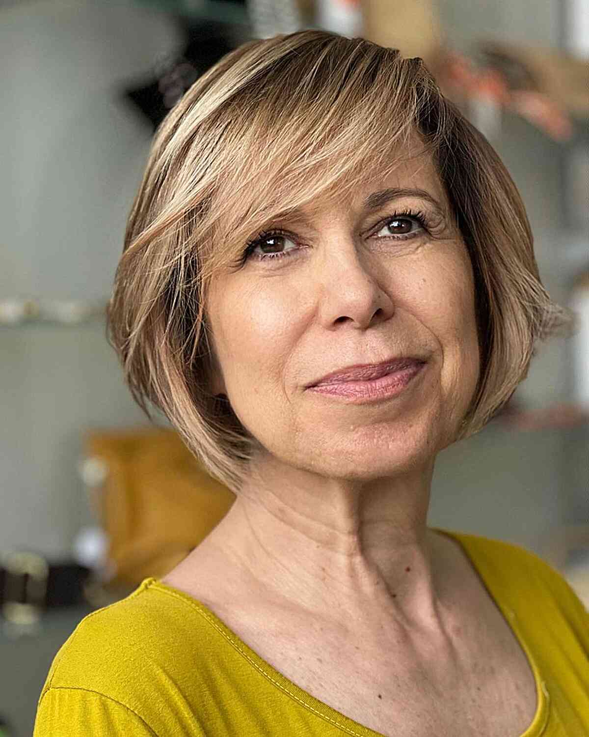 Sweeping Fringe on a Light Brown Bob for Ladies Aged 60